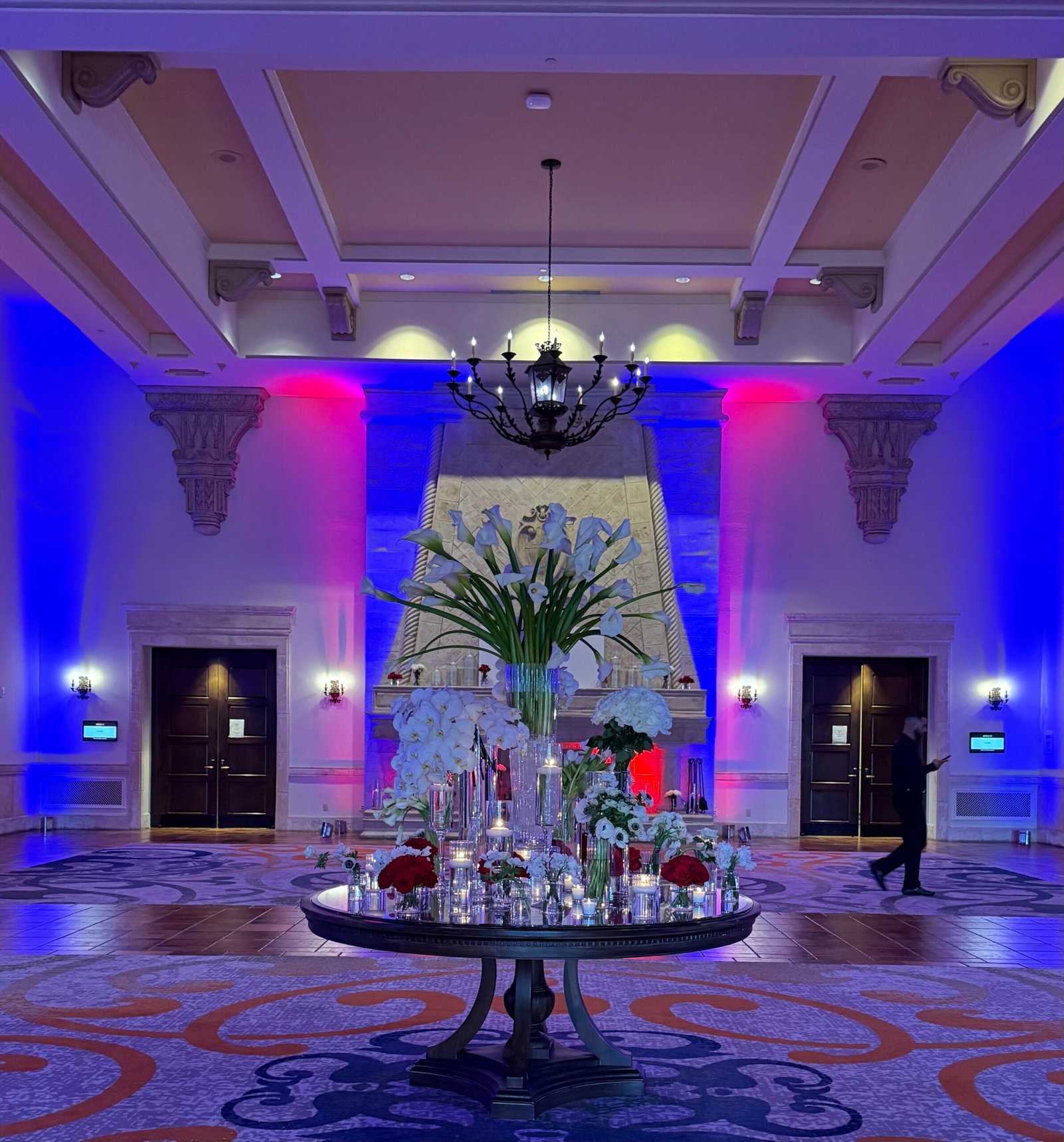 Elegant event venue with blue and purple uplighting — the types of event photographers you hire determine how moments like this are captured