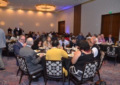A full ballroom of seated guests during an awards gala at The Wave Hotel, Lake Nona