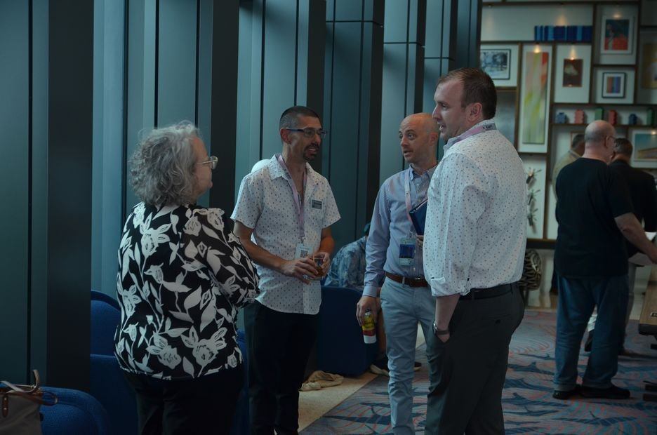 Guests talking in small groups during the reception