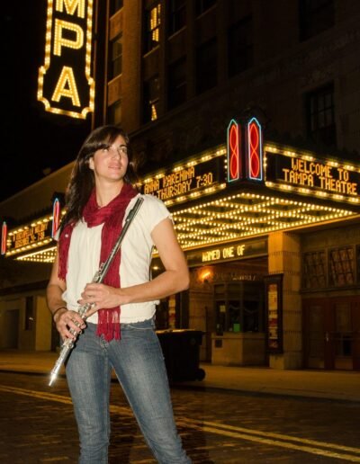 Environmental portrait of a musician beneath a theatre marquee