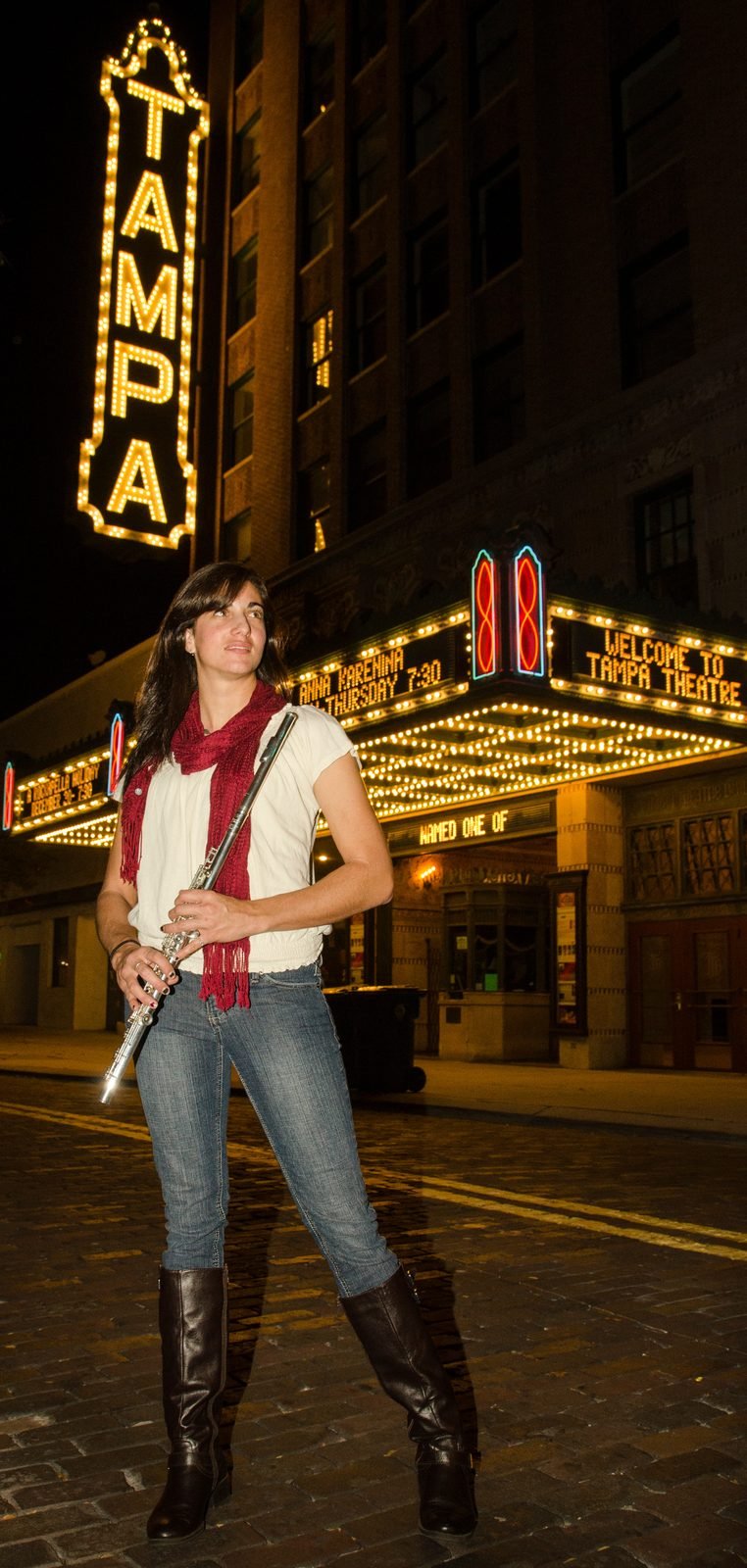 Environmental portrait of a musician beneath a theatre marquee