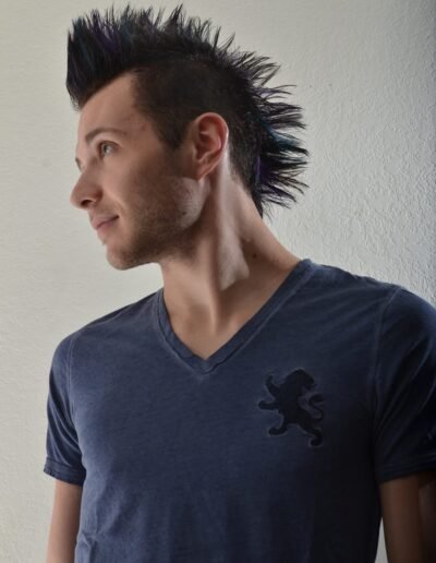 Studio headshot of a man against a light backdrop