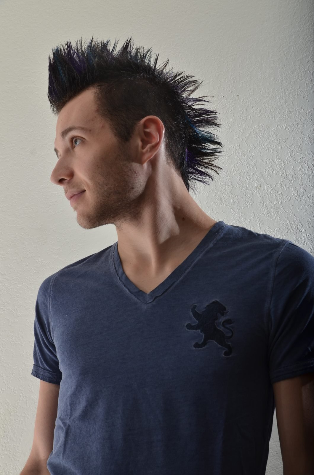 Studio headshot of a man against a light backdrop