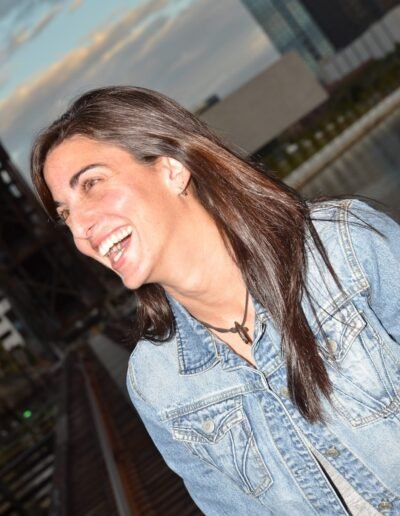 Candid portrait of a woman laughing outdoors