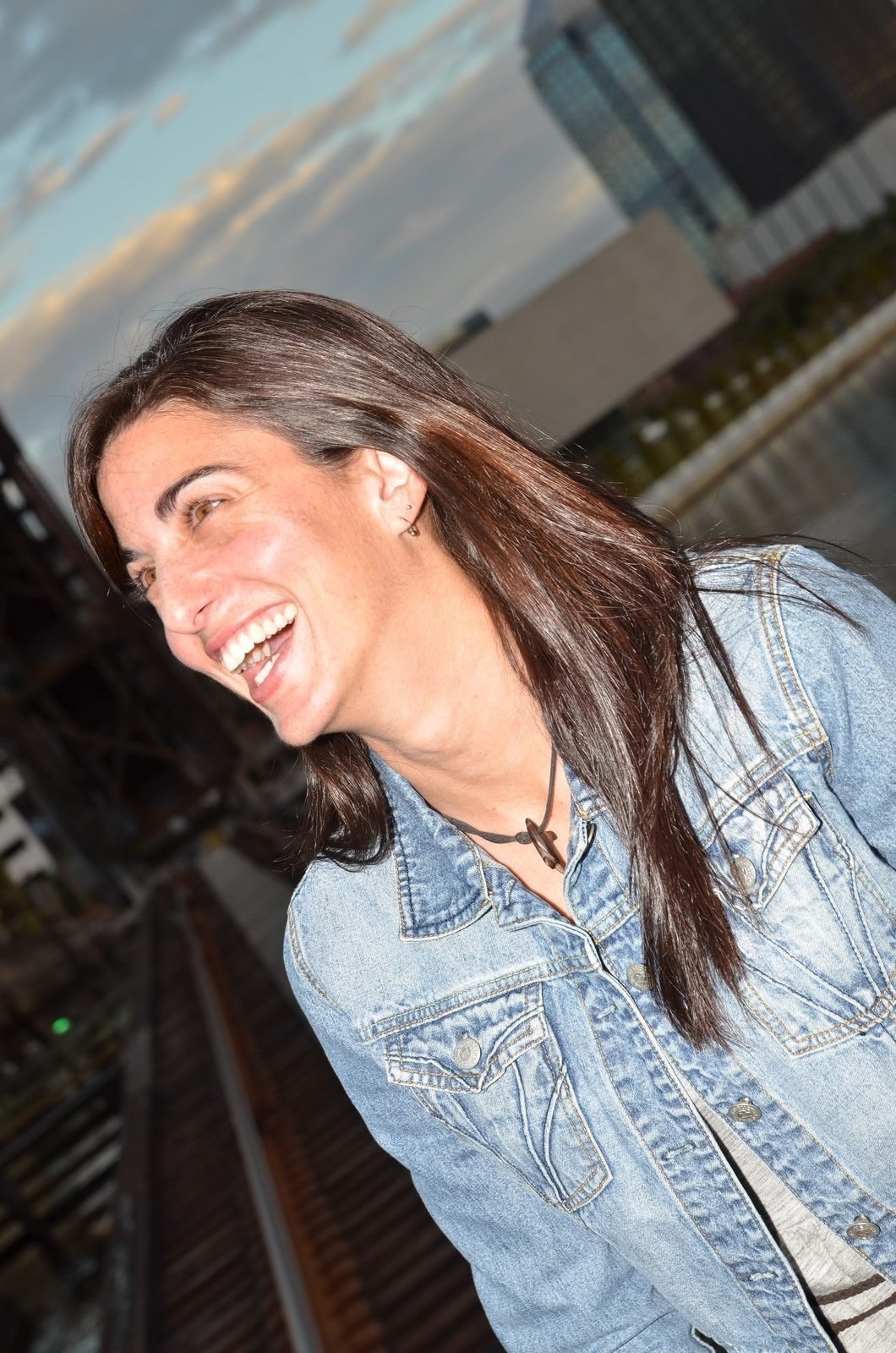 Candid portrait of a woman laughing outdoors