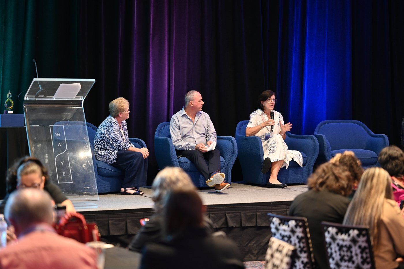 Panel discussion on stage at a corporate event at The Wave Hotel, Lake Nona, Orlando