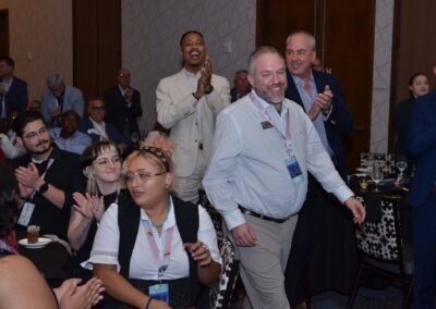 Guests laughing at their table during an event programme in Orlando