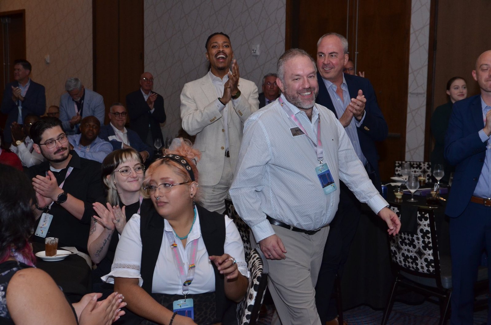 Guests laughing at their table during an event programme in Orlando