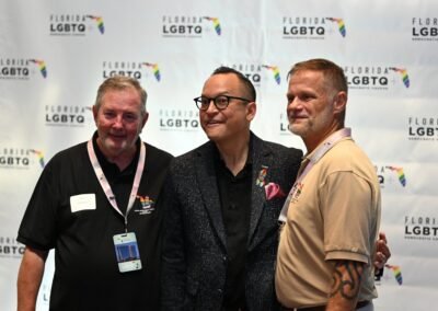 Three guests laughing together during an Orlando event reception
