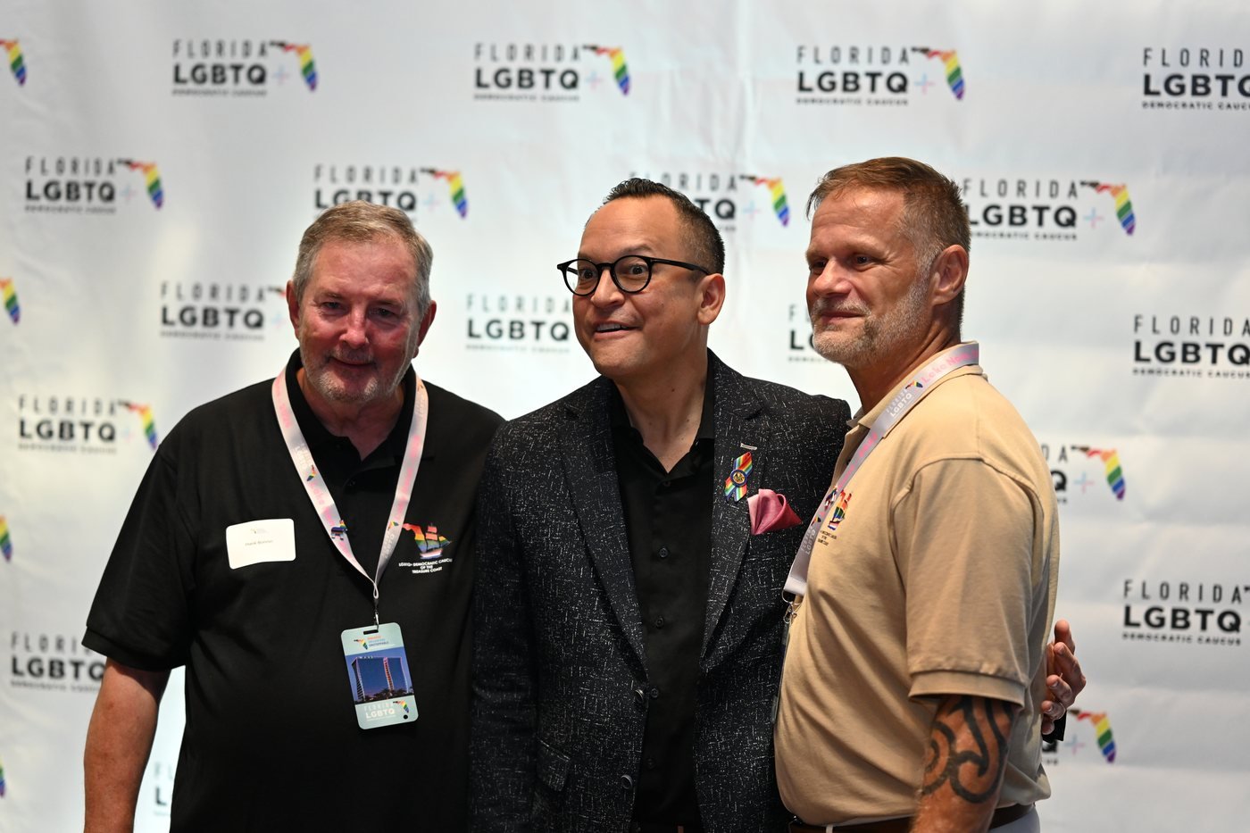 Three guests laughing together during an Orlando event reception