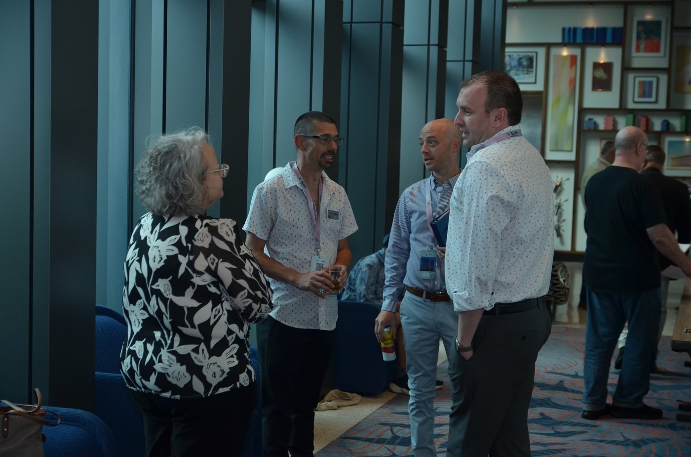 Guests talking in small groups during an event reception in Orlando