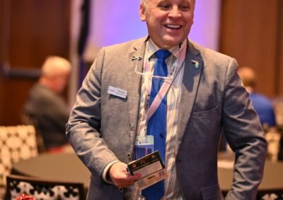A guest holding an award during an Orlando event