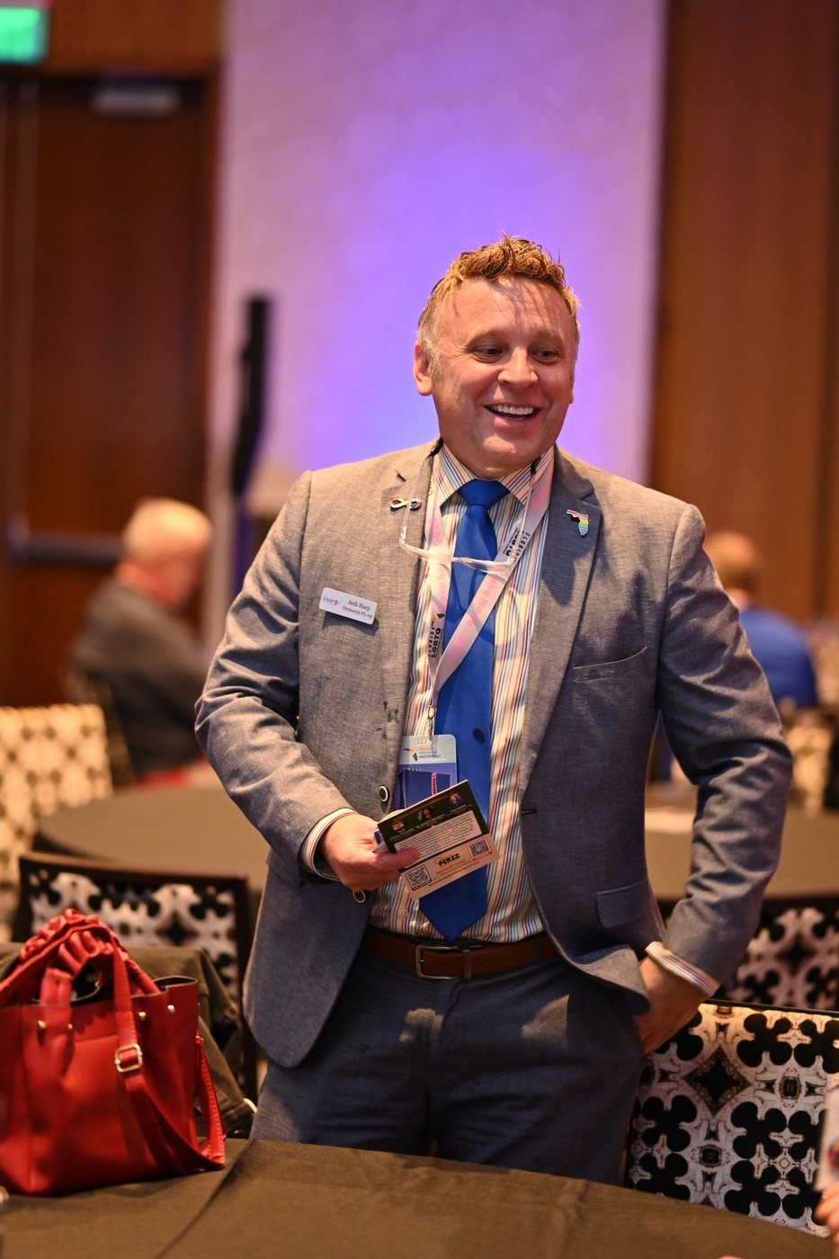 A guest holding an award during an Orlando event