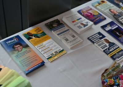 Printed event materials arranged on a welcome table at an Orlando event