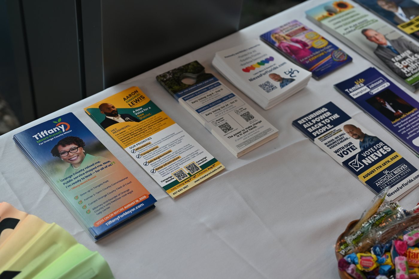 Printed event materials arranged on a welcome table at an Orlando event