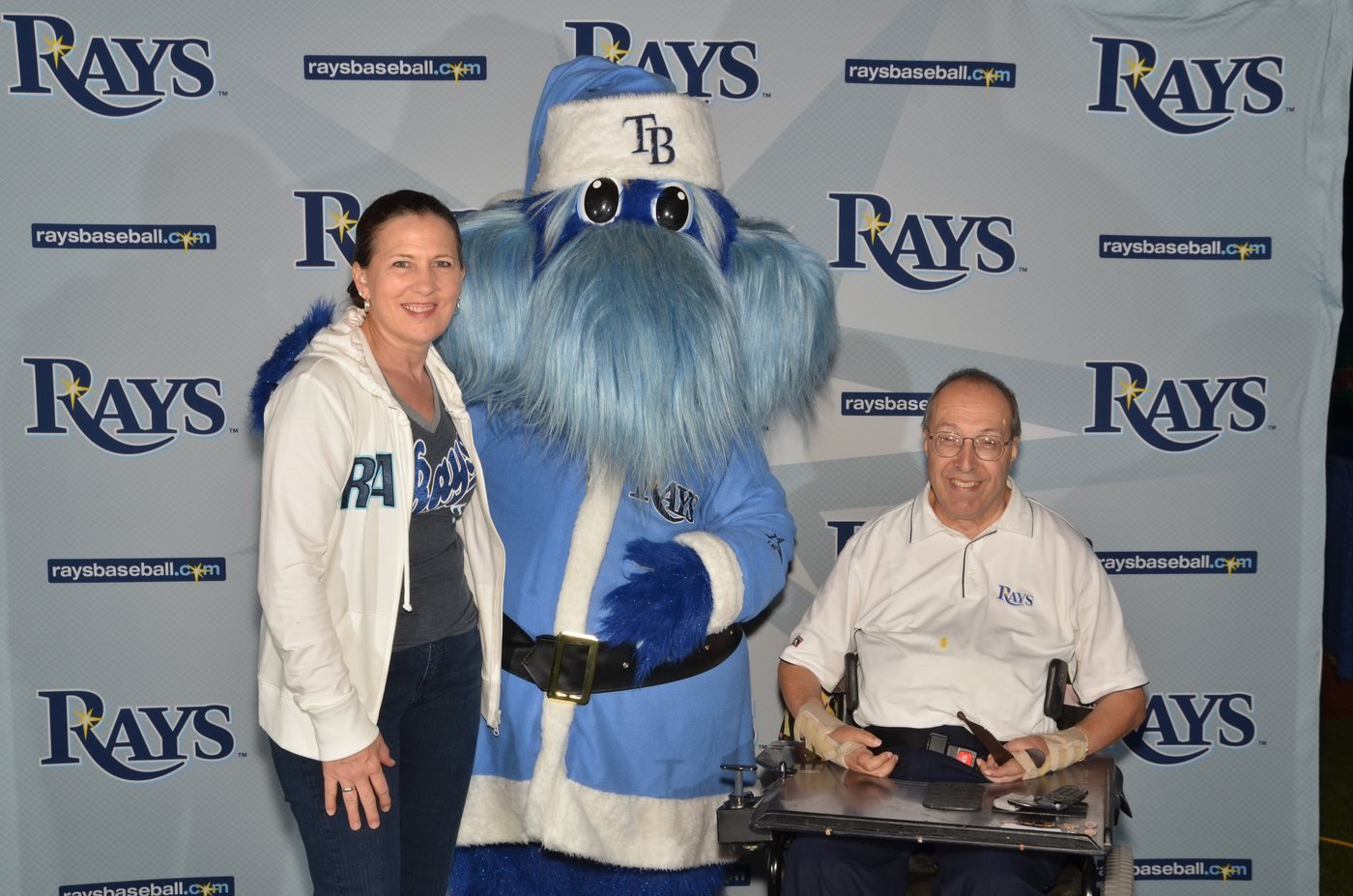 Two guests photographed with the team mascot at a sponsor activation at Tropicana Field, St. Petersburg