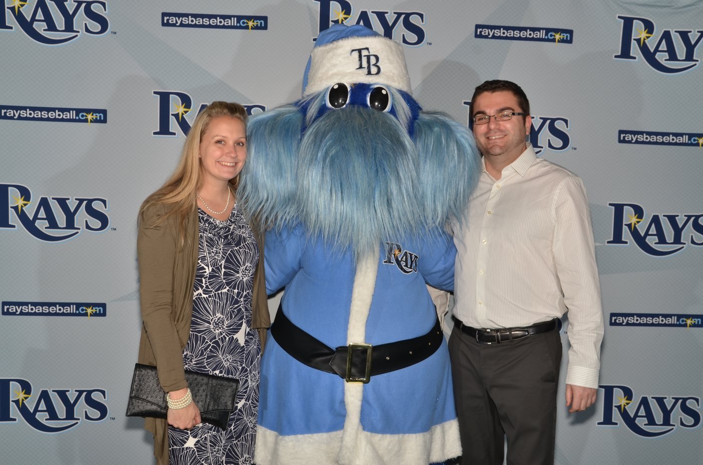Two guests photographed with the team mascot at a branded backdrop at Tropicana Field, St. Petersburg